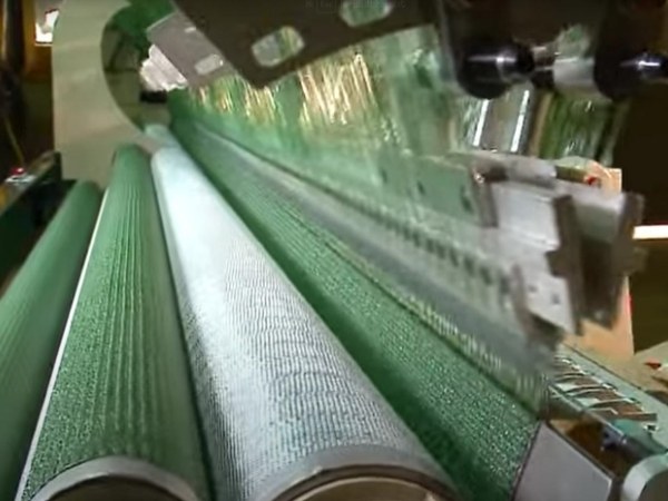 The machine is braiding plastic net.